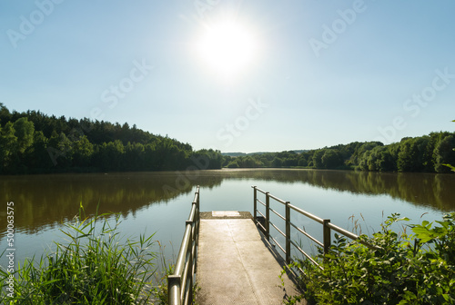 Fototapeta Naklejka Na Ścianę i Meble -  Large pond with jetty in summer, rural Czech Republic