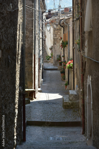 Narrow street among the houses of Villalago, a medieval village in the Abruzzo region, Italy photo