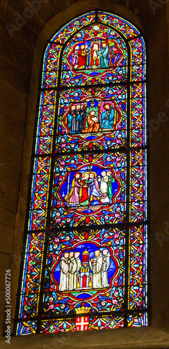 Vertical shot of a stained glass window in the Church of Notre Dame of Dijon. France. photo