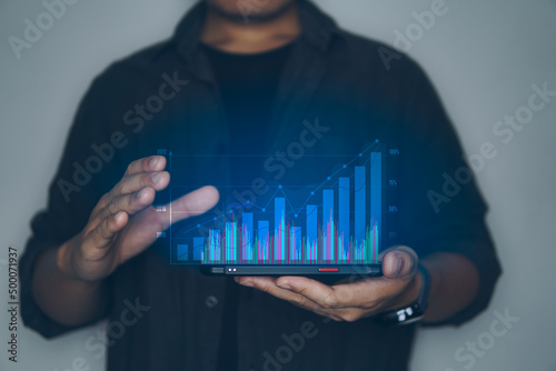 Concept of business technology, business people holding smartphone with show the graph of business on visual screen