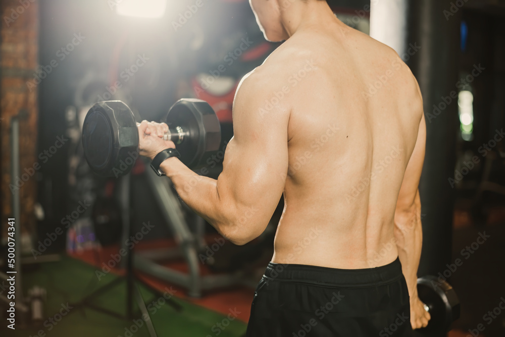 Back muscles of Asian bodybuilders when lifting dumbbells with arms. Back muscles of Asian bodybuilders when lifting dumbbells with arms.