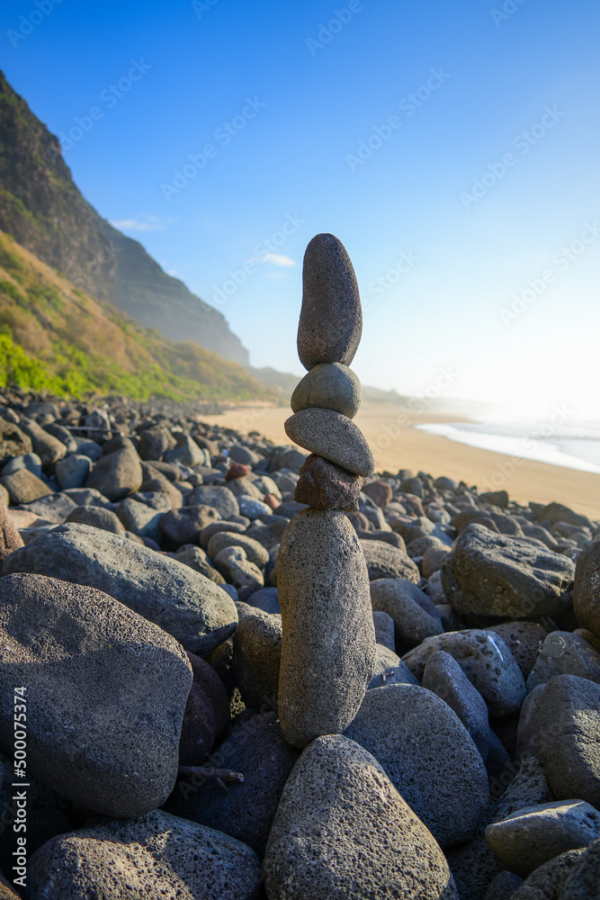Stones stacked on the beach of the Polihale State Park at the western edge of the Na Pali coast on Kauai island in Hawaii, United States Stones stacked on the beach of the Polihale State Park at the western edge of the Na Pali coast on Kauai island in Hawaii, United States