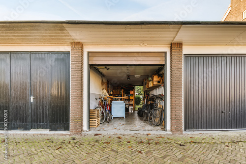 Opened garage with bicycles in backyard photo