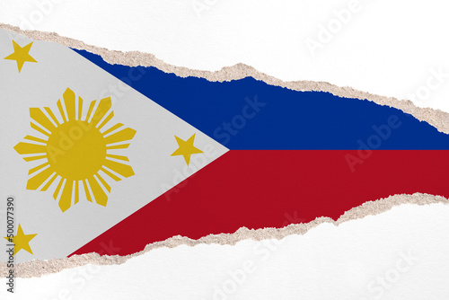Ripped paper background in colors of national flag. Philippines
