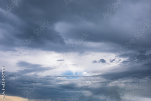 Gloomy stormy sky with thick gray clouds, cloudscape natural background