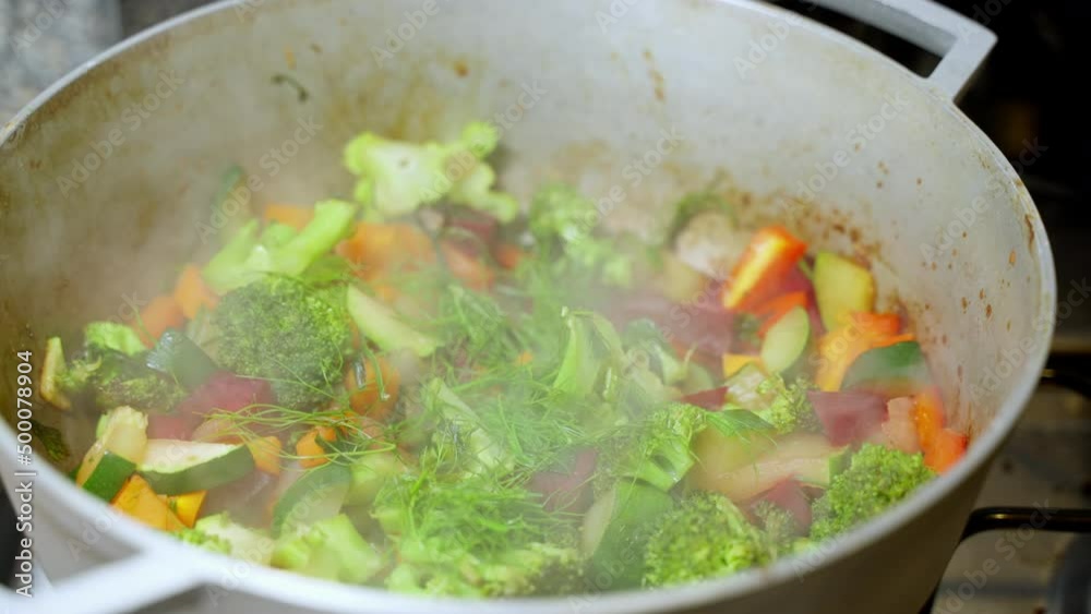 Hot Steam Rising From Vegetable Pot With Broccoli, Zucchini, Carrots. Slow Motion Hot Steam Rising From Vegetable Pot With Broccoli, Zucchini, Carrots. Slow Motion