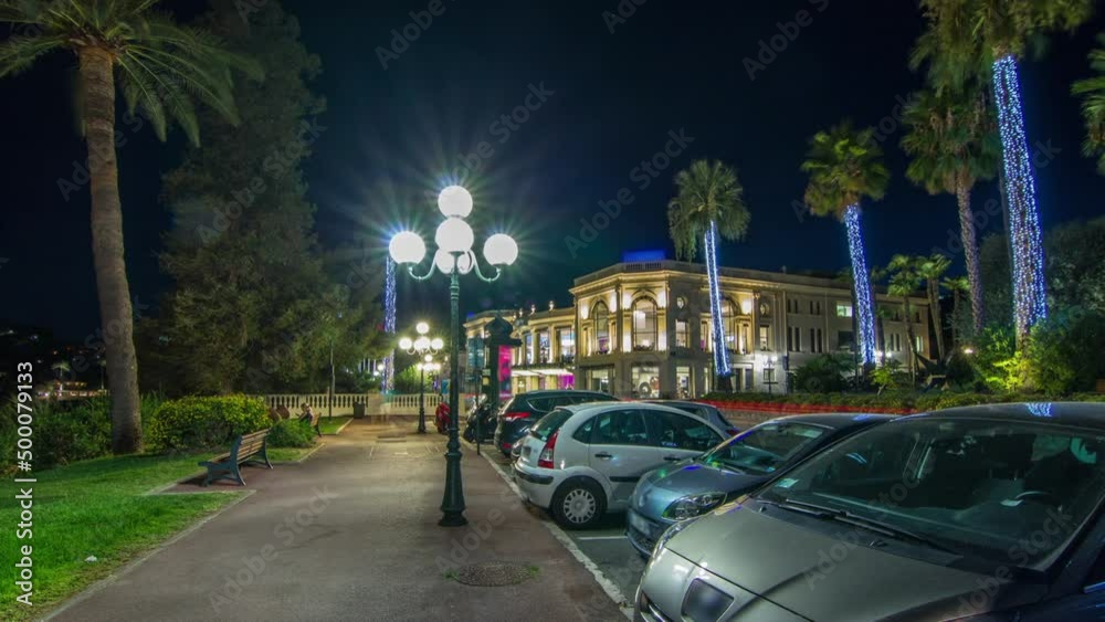 Night view to street with palms on the center of Beaulieu-sur-Mer timelapse hyperlapse.