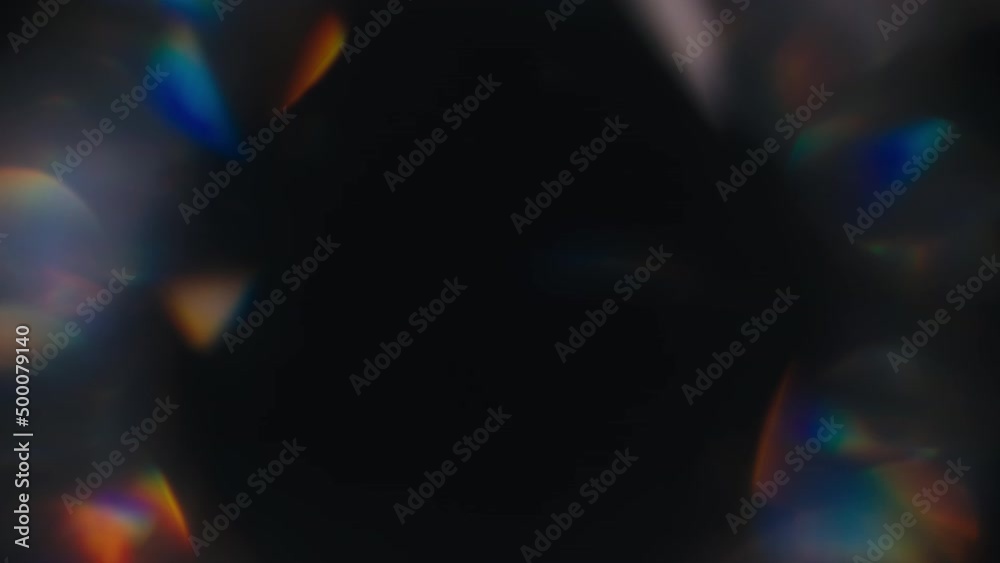 Blurred light reflections leaks spinning on a black background