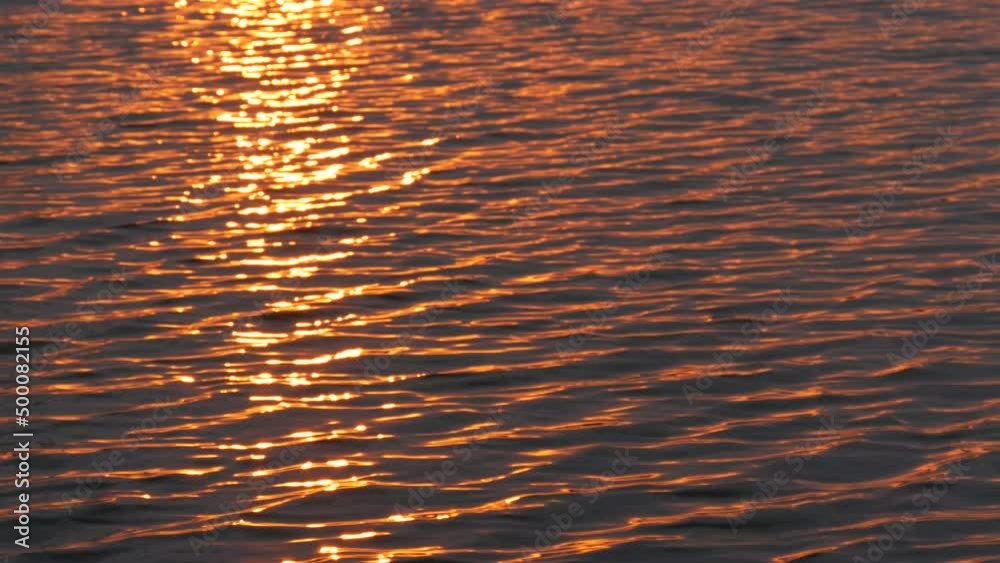 The rays of the setting red sun on the water surface The rays of the setting red sun on the water surface