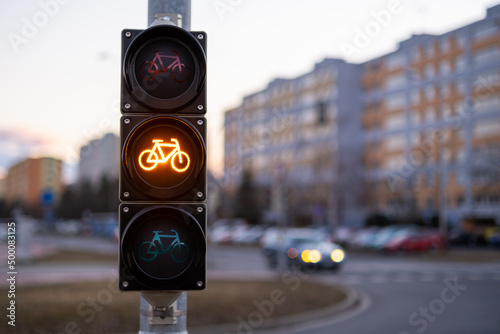 Traffic yellow light forbids bicycles to pass in public place. 