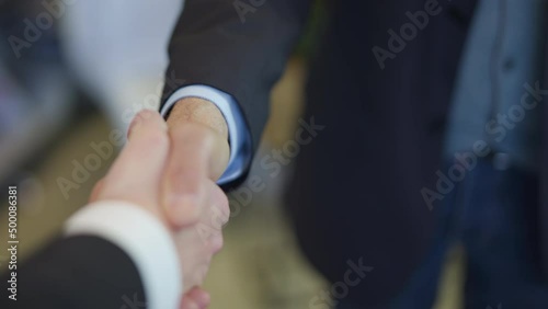 POV shot personal perspective shot of a businesswoman shaking hands with a businessman in the office.