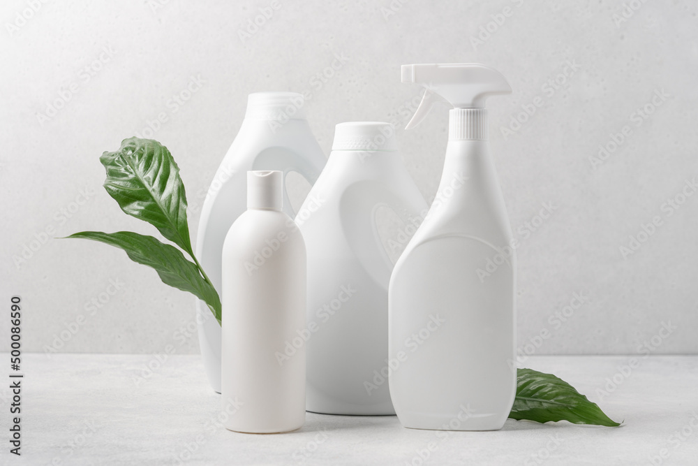 Set of white bottles with cleaning products on white background. Cleaning service concept Set of white bottles with cleaning products on white background. Cleaning service concept