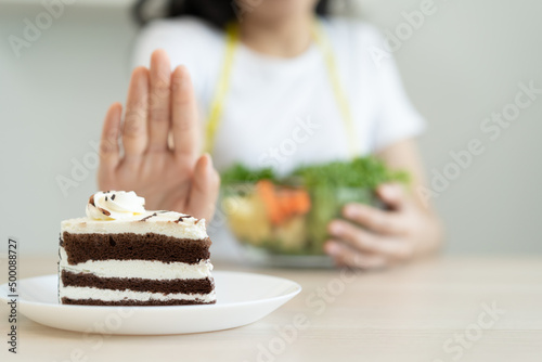 eat less sugar for health, women avoid to eat chocolate cake and sweets during sugar diet session for lose weight