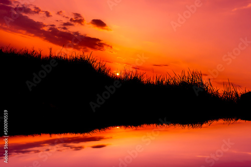 Amazing sunset and sunrise.dramatic sunrise.Safari theme.Silhouette Meadow beside the river.