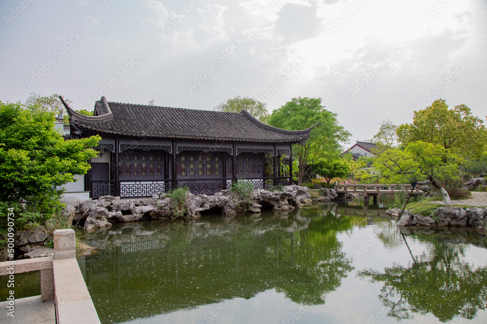 An ancient Chinese style building by the pond. An ancient Chinese style building by the pond.