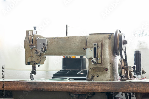 Old sewing machine on a table with a window in the background
