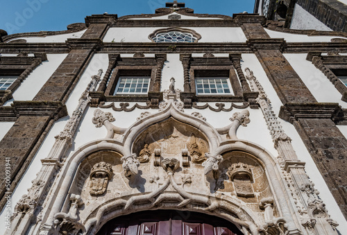 Manueline details, windows, rose window and cross on the facade of the São Sebastião Church in Ponta Delgada, São Miguel - Azores PORTUGAL