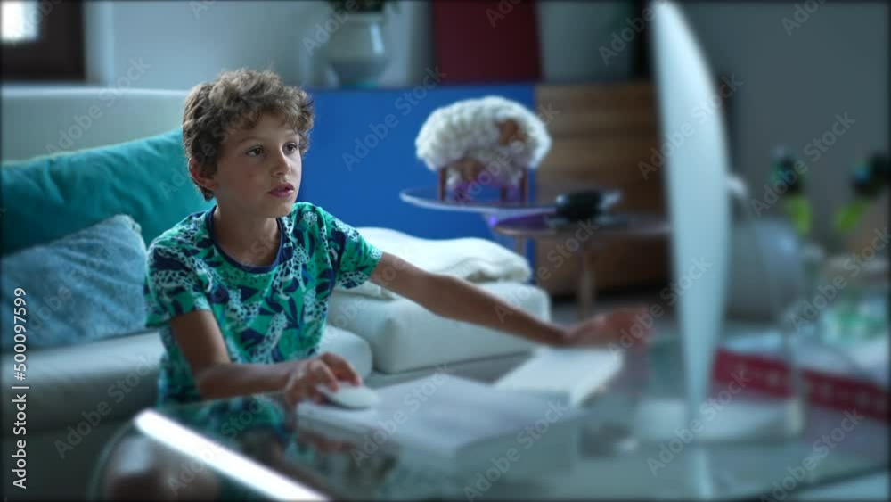 Young boy using computer desktop browsing internet Young boy using computer desktop browsing internet