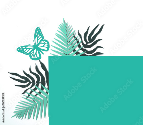 Turquoise Blue and Green Tropical Leaves on a White Background. Simple Modern Composition with Paper Cut Palm Tree Leaves, Frame and Butterfly ideal for Card, Banner, Greetings. Top-Down View.No text.