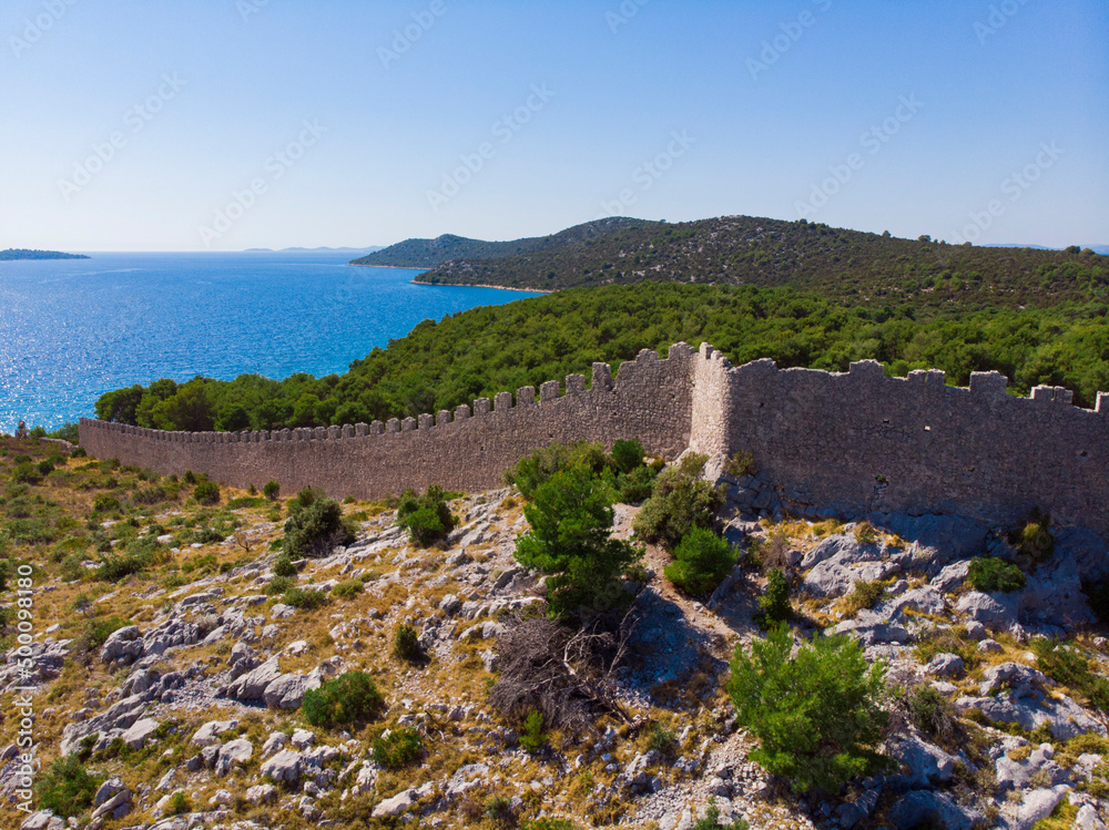 Croatia. Summer. Sunny day. Coast of the Adriatic Sea. Ruins of an ancient fortress. Holiday season. Popular tourist spot. Drone. Aerial view