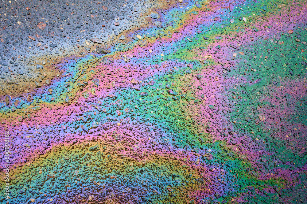 Gasoline spill on the pavement resembling a rainbow