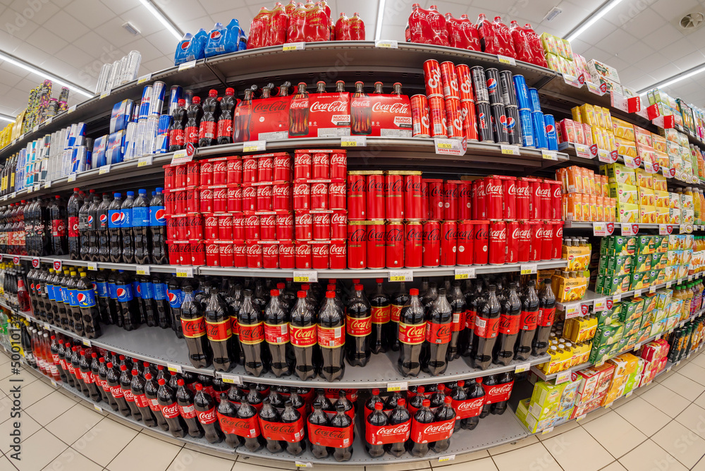 Fossano, Italy - April 20, 2022: Shelves with packages of beverage Coca cola  and Pepsi Cola also in light version, zero sugar, for sale in an Italian  supermarket, fish eye vision Photos | Adobe Stock