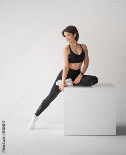 Sexy fitness woman on a white background