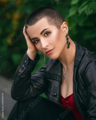 young beautiful girl with short hair in a leather jacket