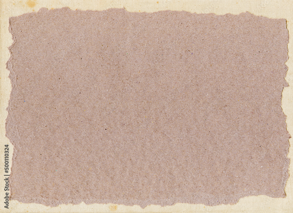 Fototapeta premium Craft paper with torn edges on natural background of canvas