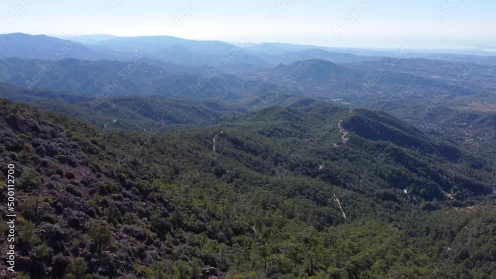 Aerial views of endless mountain layers filled with forest trees during a beautiful sunny day. Aerial views of endless mountain layers filled with forest trees during a beautiful sunny day.
