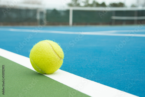 Tennis ball on a court line