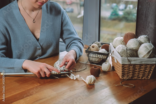 Knitting.Girl knitting at home.Handmade zero waste,upcycling,New small business employment opportunity concept.Hobby knitting and needlework for mental health.Knitted background,eco friendly knitting photo