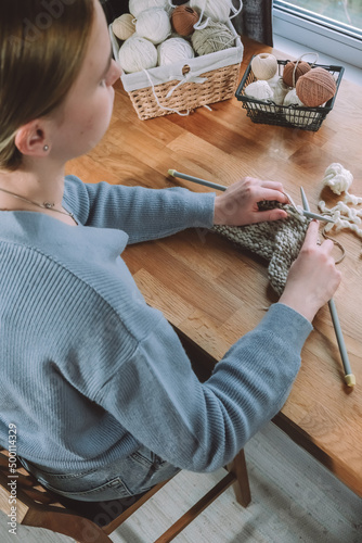 Knitting.Girl knitting at home.Handmade zero waste,upcycling,New small business employment opportunity concept.Hobby knitting and needlework for mental health.Knitted background,eco friendly knitting photo