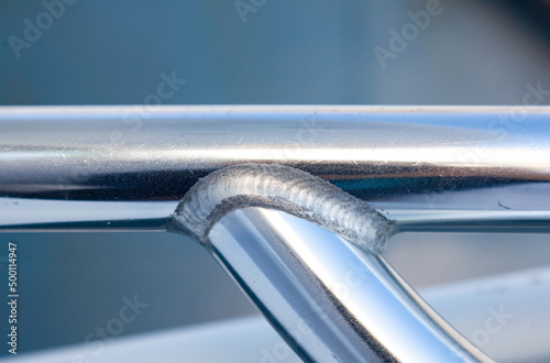 Welding joint of aluminum tubes close-up.