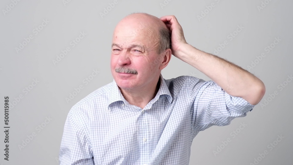 Not sure. Mature adult in shirt having a doubt Not sure. Mature adult in shirt having a doubt