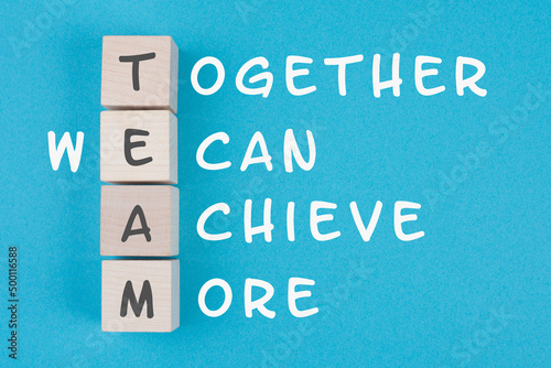 Team, together we can achieve more is standing on wooden cubes, business concept, teamwork strategy photo
