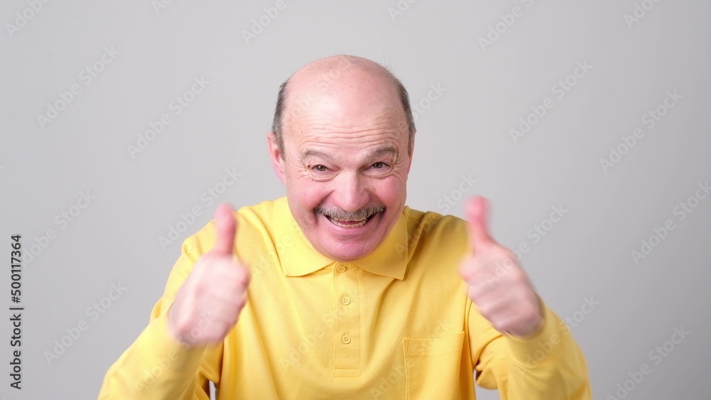 senior man shows thumb up. He approve your choice. senior man shows thumb up. He approve your choice.