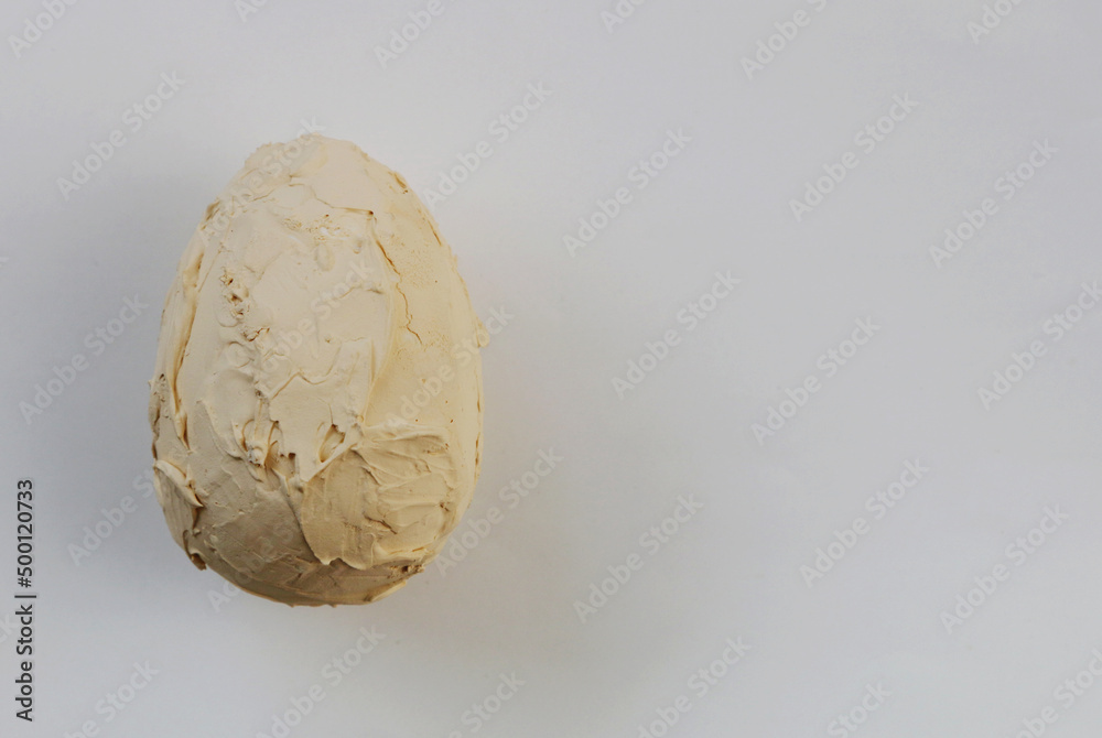 Decorative egg covered with plaster on the background. Decorative egg covered with plaster on the background.