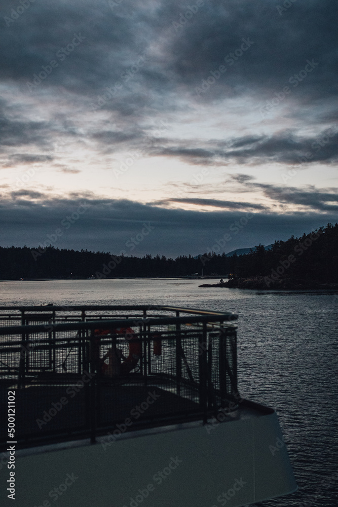 gray sky, dusk, sunset during ferry boat ride in the pacific northwest