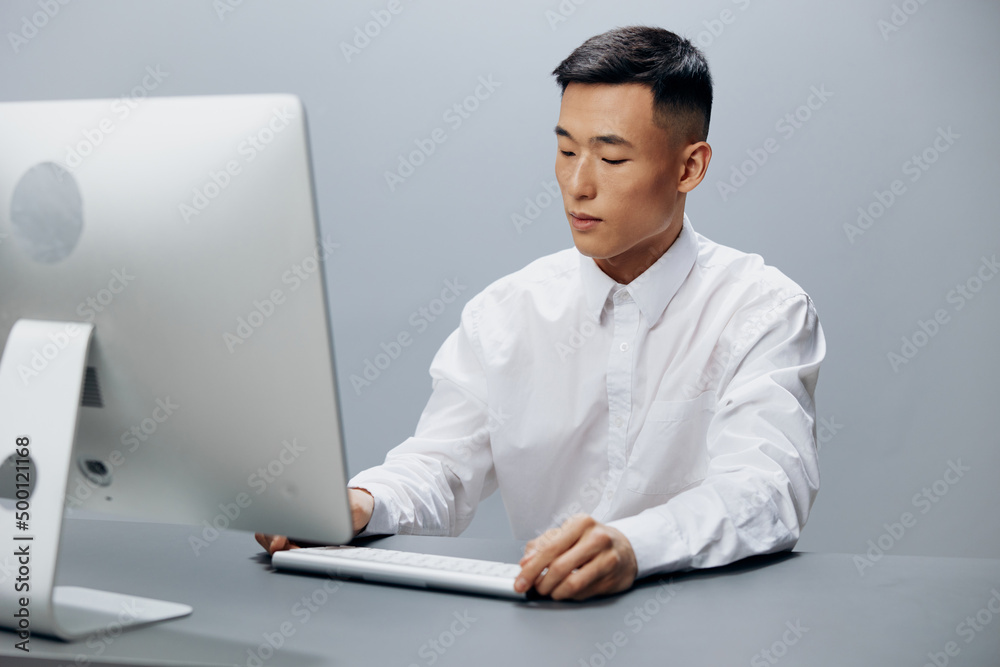 businessmen in a white shirt works at a computer in the office technologies businessmen in a white shirt works at a computer in the office technologies