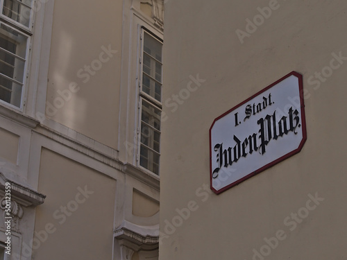 Photography Close-up view of street sign on the facade of an old building in the center of the historic downtown of Vienna, Austria