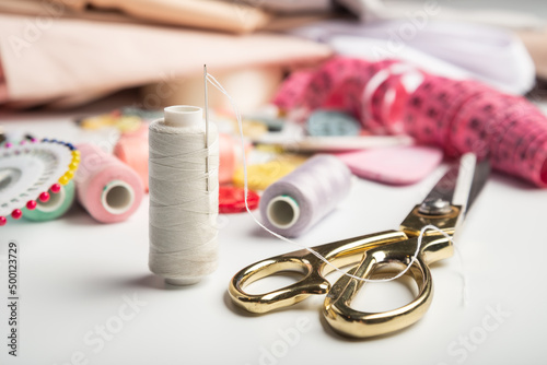 Needle and thread and sewing scissors