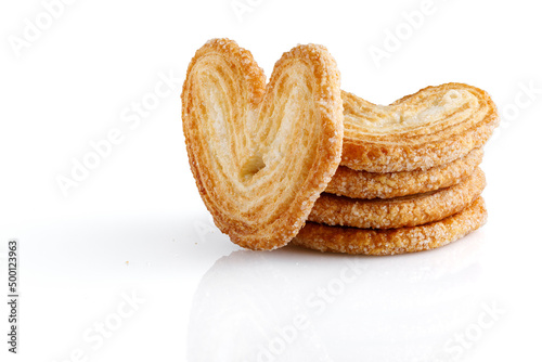 Palmier cookies or puff pastry ears isolated on white background. Cookies in the shape of a heart. Full depth of field. Close-up.