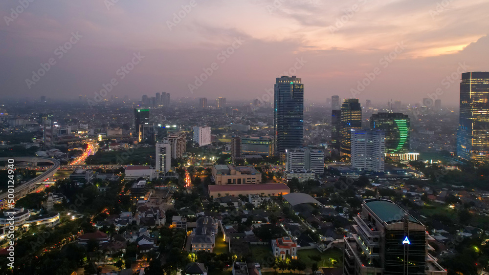 Aerial view of office buildings in Jakarta central business district and noise cloud when sunset. JAKARTA, INDONESIA - APRIL 21, 2022