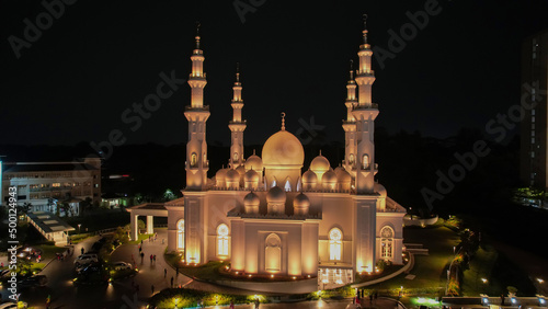 Aerial view of At-Thohir Mosque panorama at nihgt view Largest Mosque in Depok Place to visit in Indonesia. Depok, Indonesia, April 21, 2022