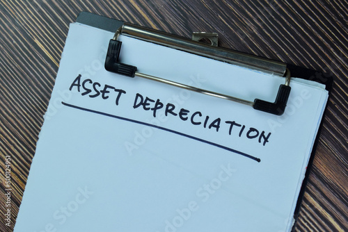 Asset Depreciation write on a paperwork isolated on Wooden Table. photo