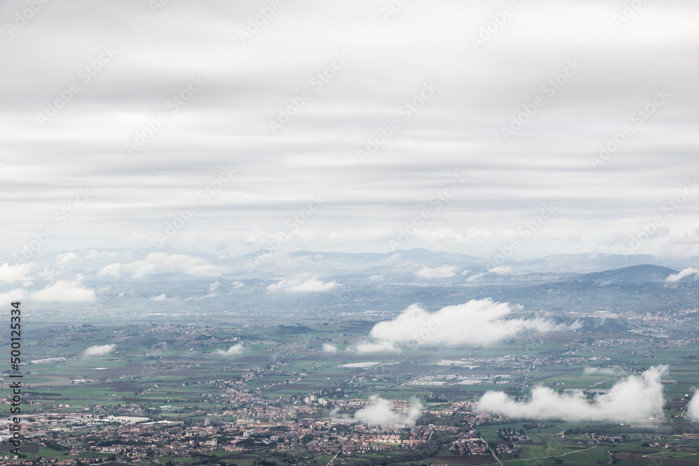 View from above of Umbria valley, with cloudscape both above and below
