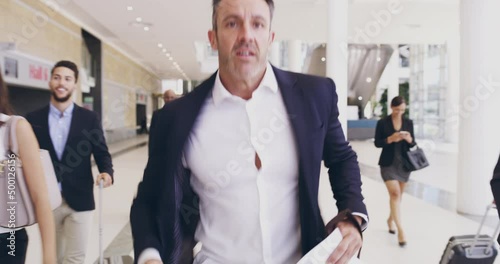 Hurrying on towards his next big opportunity. 4k video footage of a mature businessman running amongst a group of businesspeople in a convention centre. photo