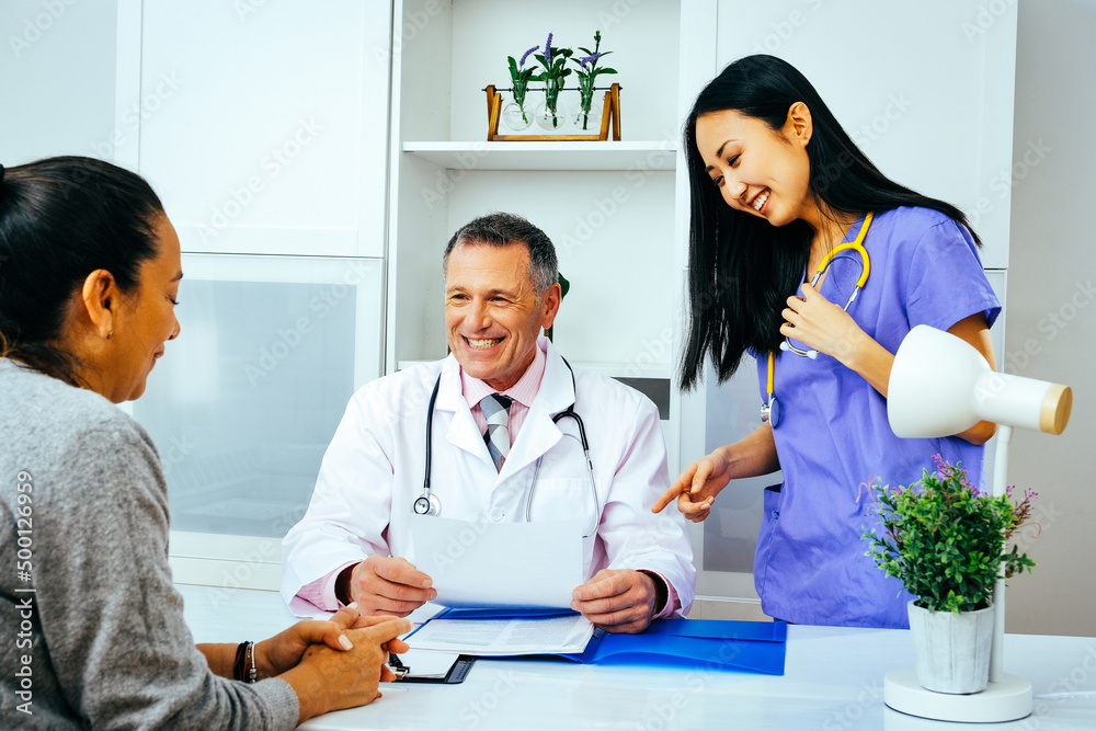 happy doctor and nurse talking to adult female patient in hospital consultation healthcare industry happy doctor and nurse talking to adult female patient in hospital consultation healthcare industry