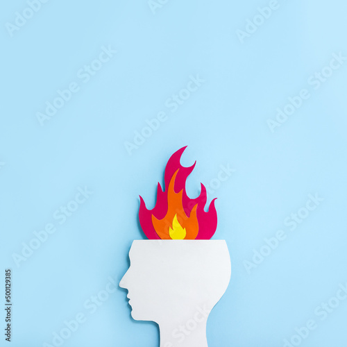 Cardboard application of the silhouette of human head and flame. Minimal concept of professional and emotional burnout. Square orientation, copy space